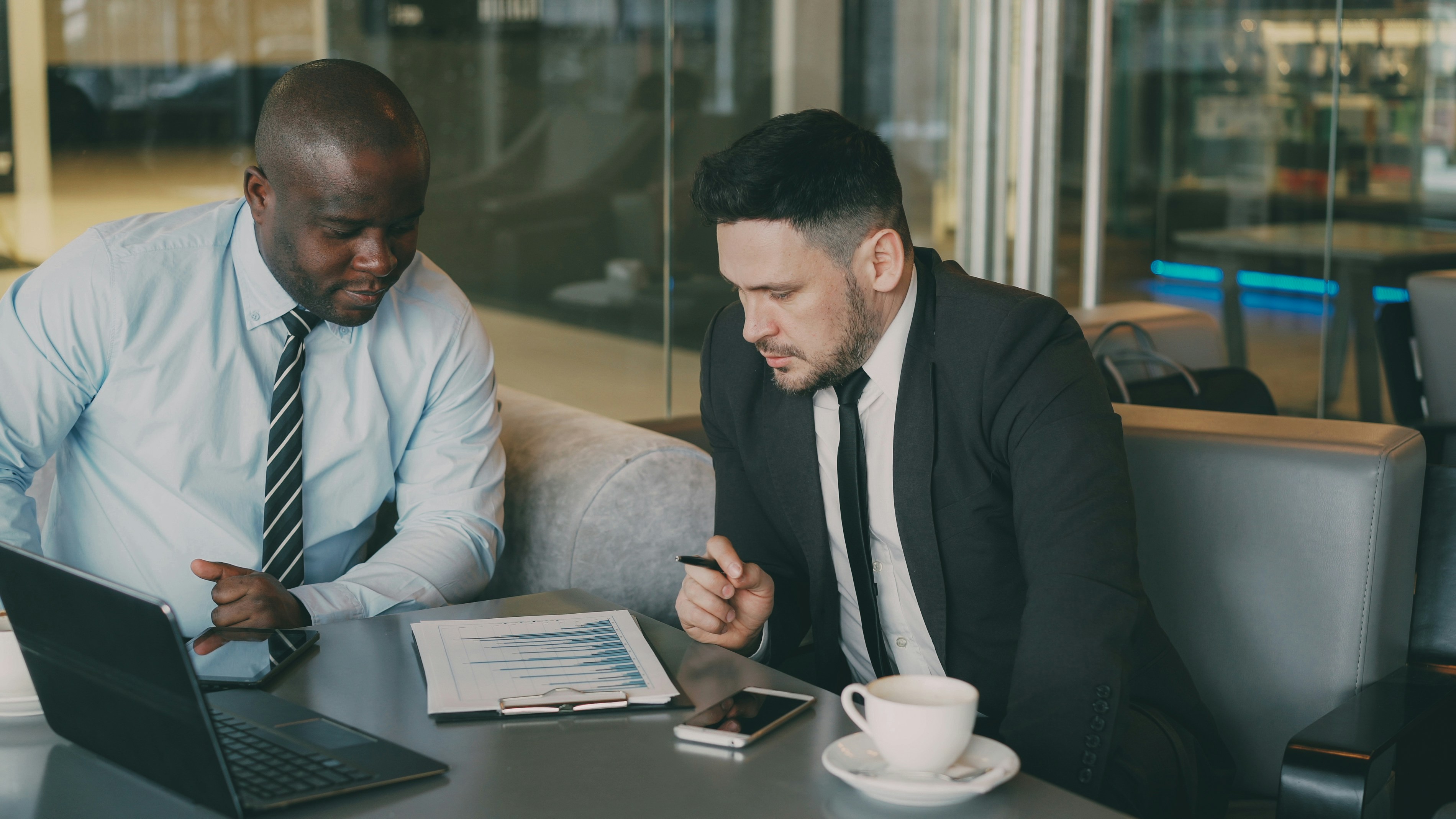Two advisors reviewing financial reports together